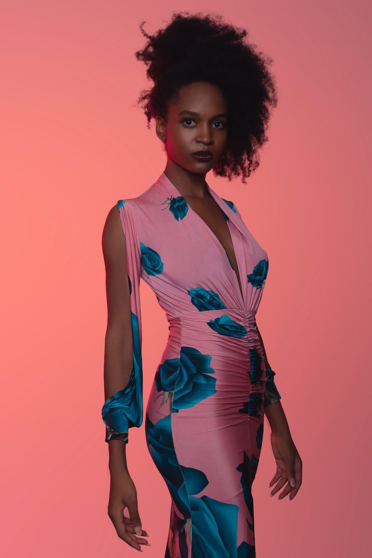 Beautiful Woman Wearing A Pink Tight Dress With Blue Roses Patterns In